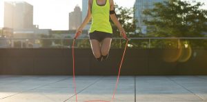 stock photo of young fitness woman jumping rope