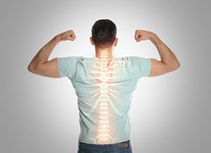 Stock photo of a male flexing while viewing his spine