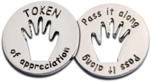 Round token with the words, Token of Appreciation and Pass it Along on the other side.
