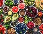 Colorful fruits and vegetables including avocado, grapefruit, berries, bananas and more