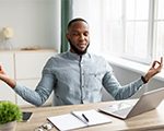 man sitting at desk practicing mindfulness