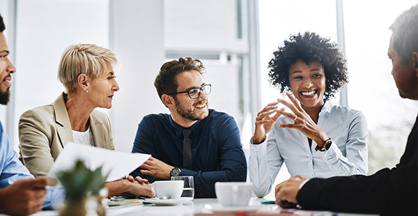 Group of people talking with coffee mugs on table