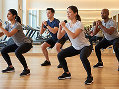 group of people doing squat exercise