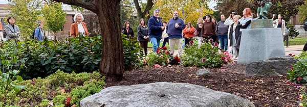 group of employees standing by tree of forty fruits